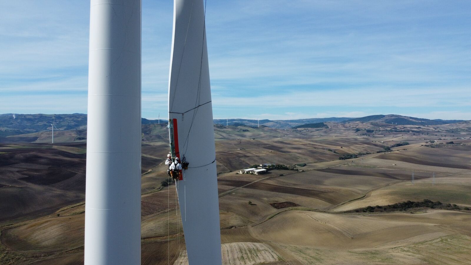 Rope access technicians repairing a wind turbine blade